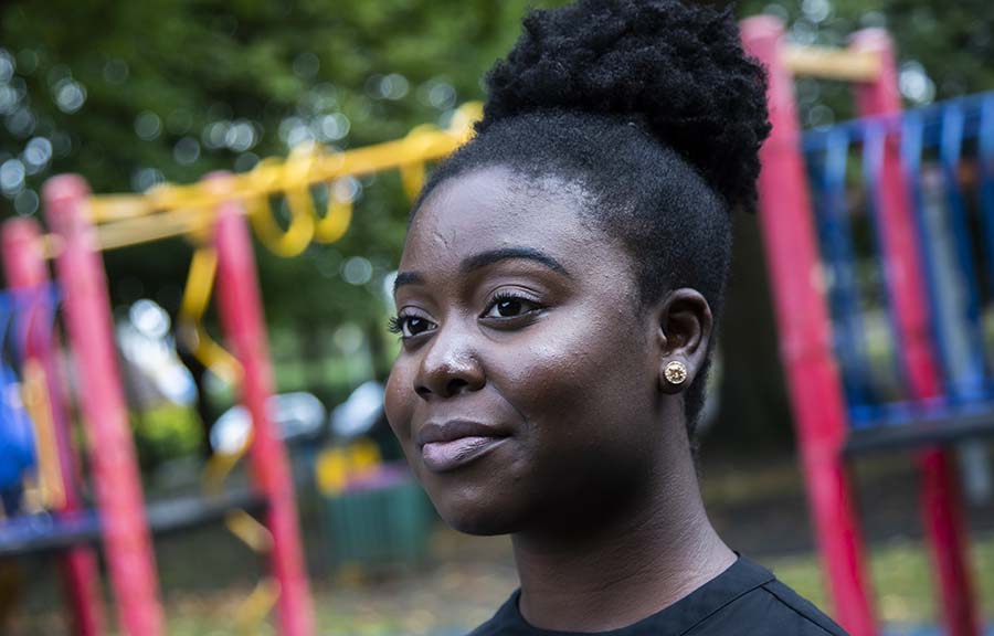 Headshot of a student standing by a playground