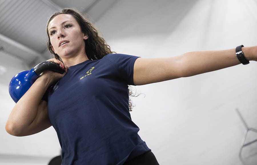A sport student living a kettlebell