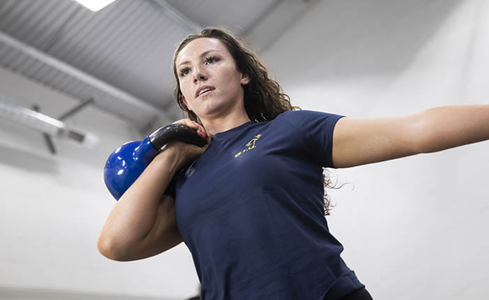A sport student living a kettlebell