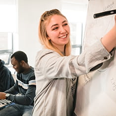 Student writing on whiteboard