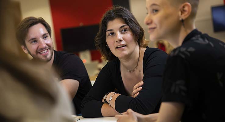 Three people discussing ideas
