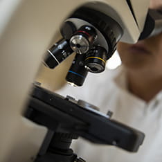 Close-up of a student using a microscope