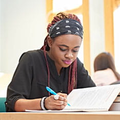 Student writing in a notebook