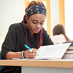 Student writing in a notebook