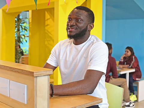 Students sitting within cluster meeting area