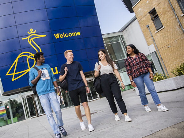 Four students walking on ARU's Chelmsford campus