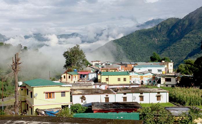 Building with the Himalaya mountain range in the distance