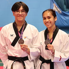 ARU students Maximo Libid and Shayanne Sarsoza holding their taekwondo medals