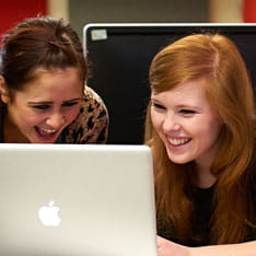 Two students using a Mac