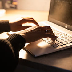 A student typing on a laptop