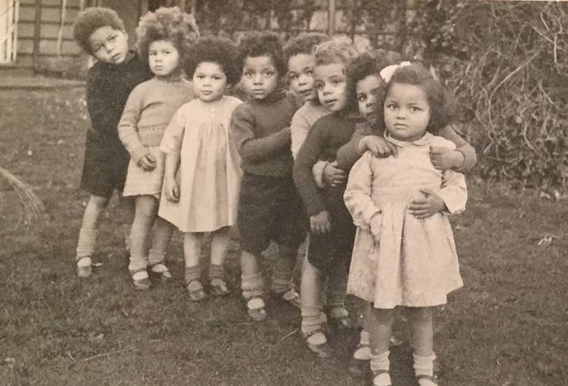 Eight young children standing in a row, photographed in the 1940s