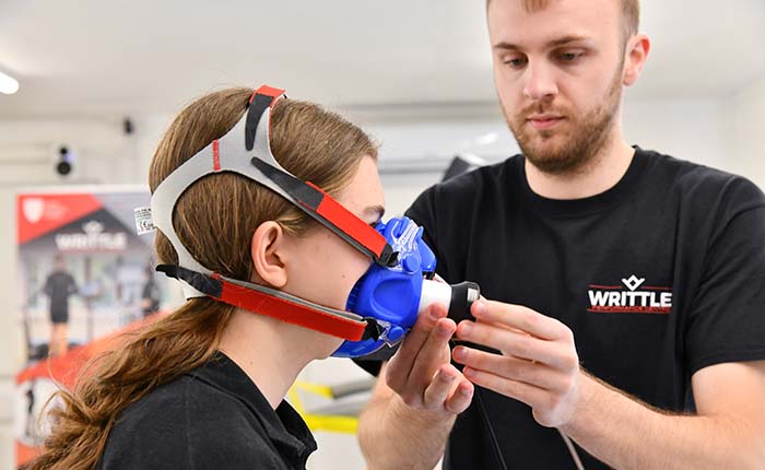 Two students using equipment to monitor sporting performance