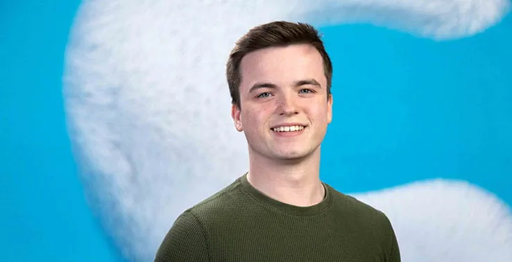 Anglia Ruskin University student pictured in front of a large letter C for Clearing