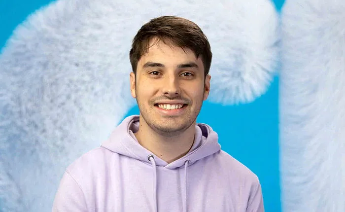 Anglia Ruskin University student Lewis, pictured in front of a large letter C for Clearing