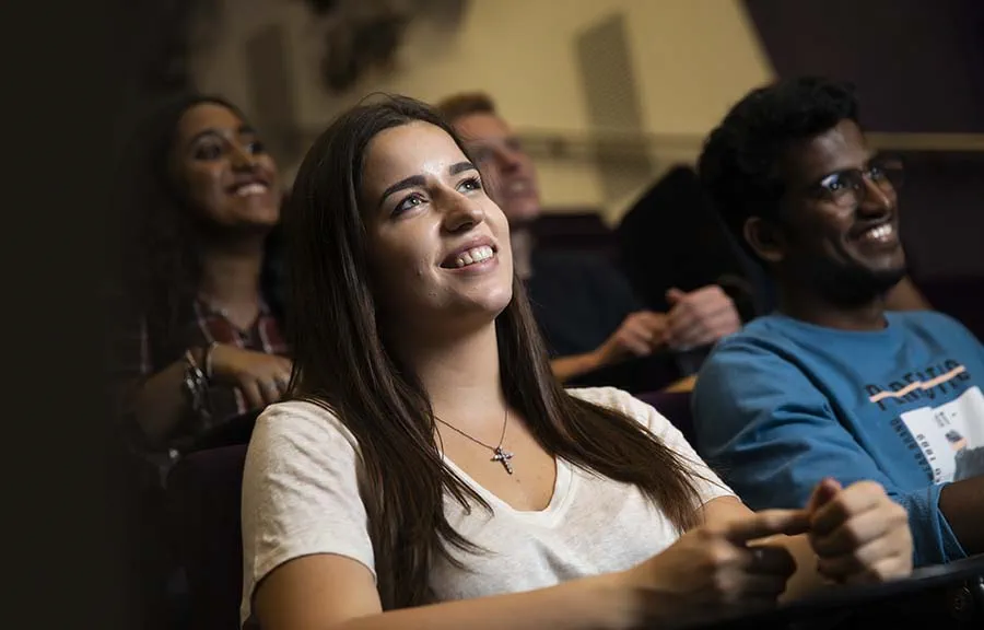 Four university students seated in a lecture theatre