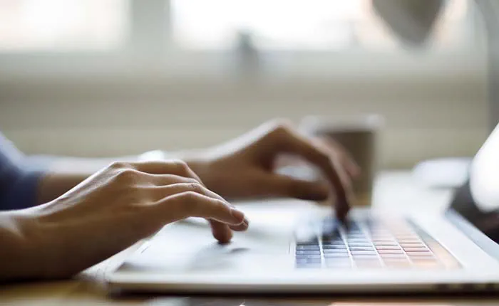 Person typing on laptop