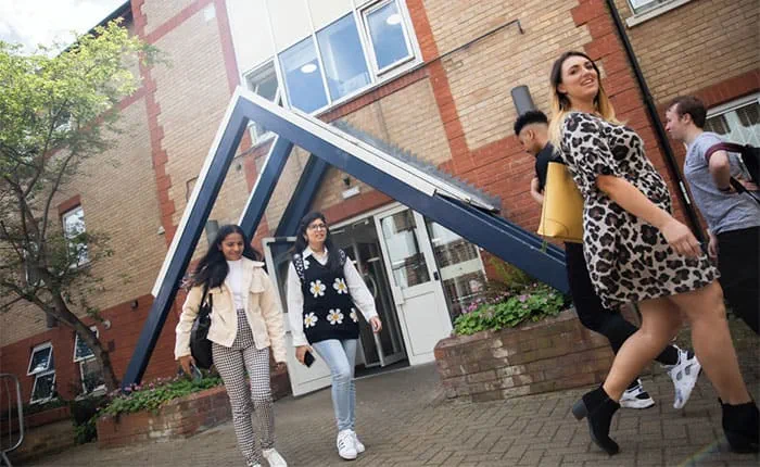 Five students walking outside Swinhoe House