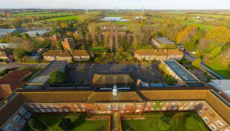 University buildings and grounds at ARU Writtle, including fields and reservoir, seen from the air